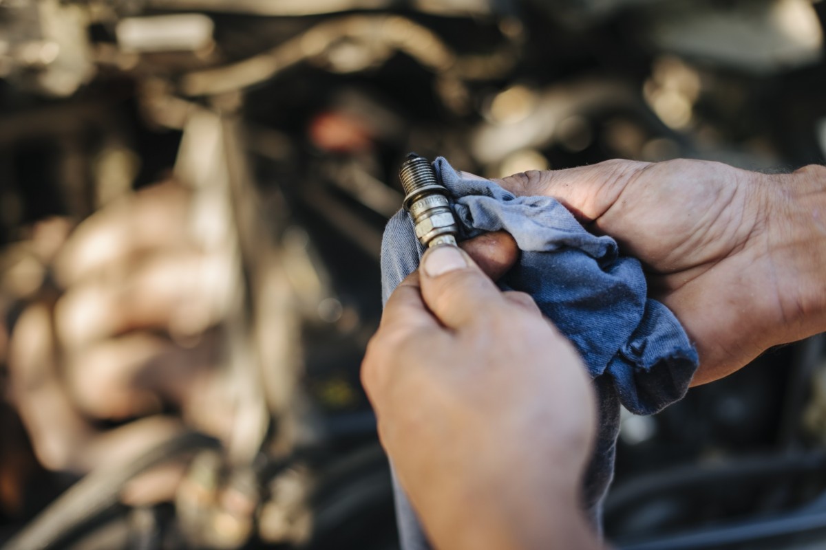 man holding spark plug in hands