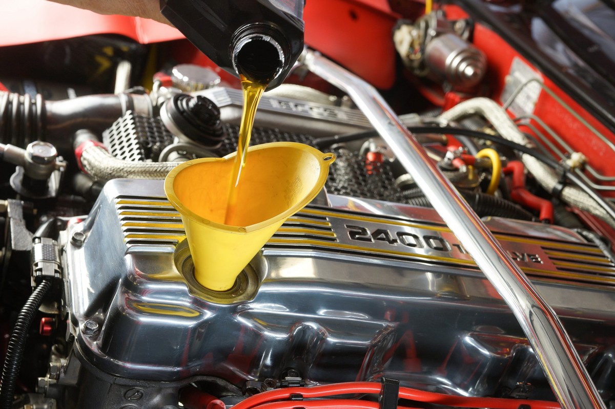 Oil being poured into a vehicle