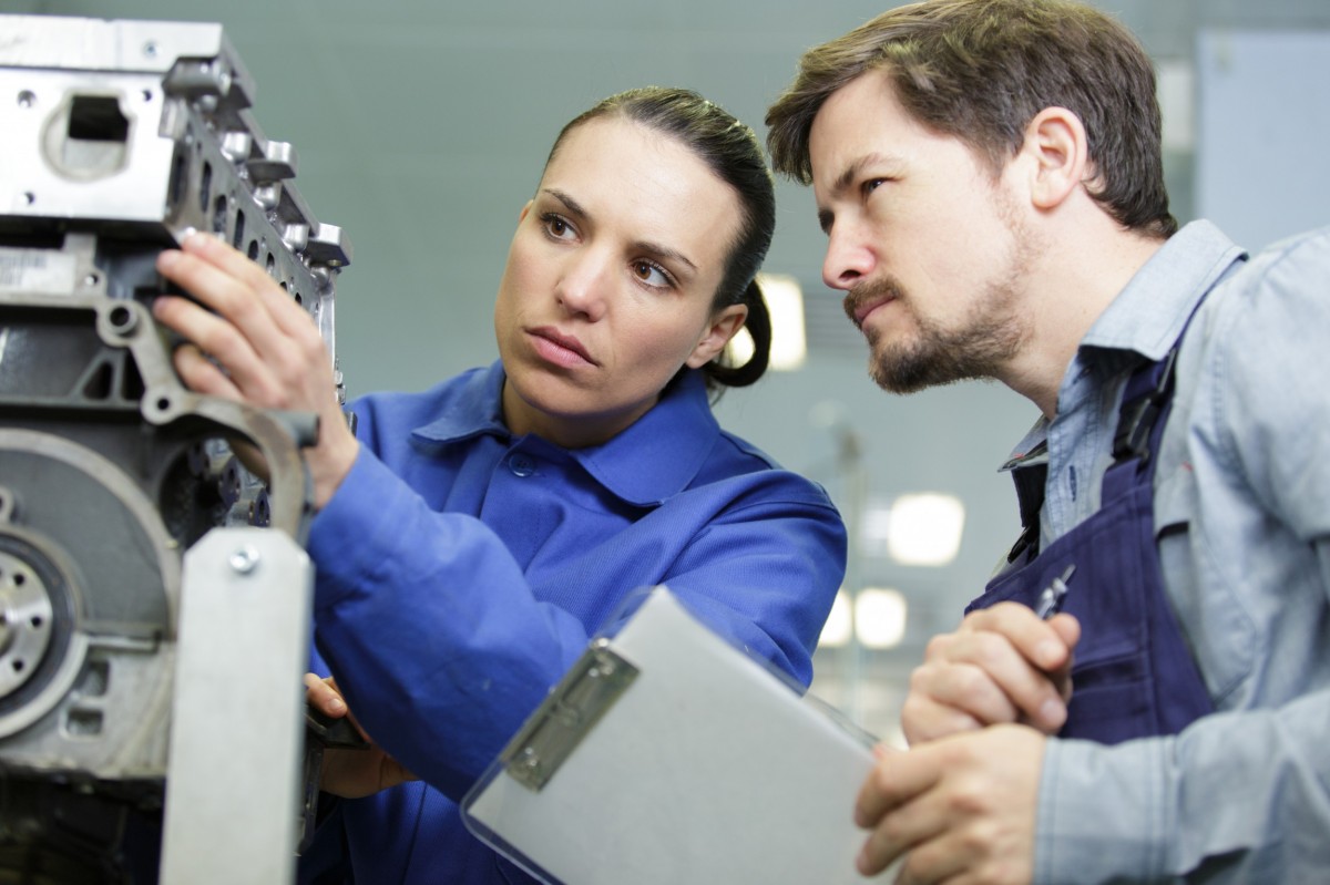 couple of technicians checking an engine